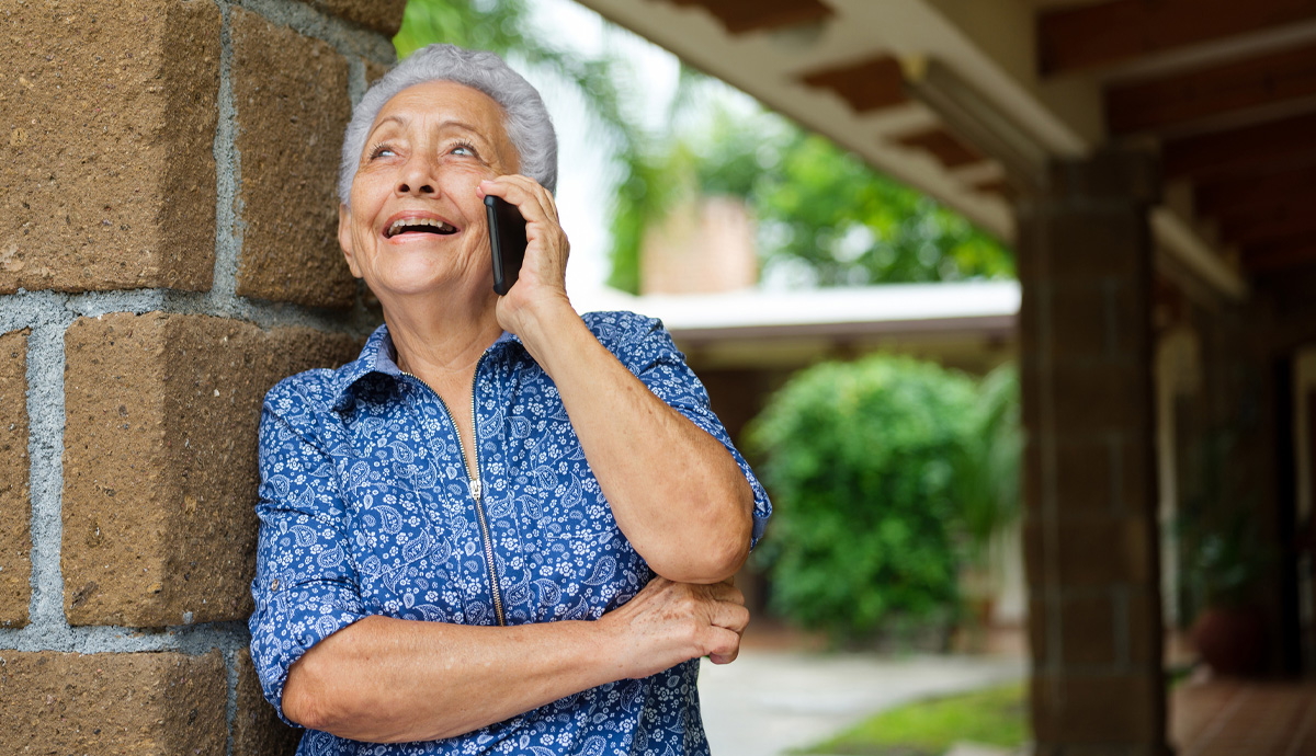 A woman talking on the phone with a positive look on her face.