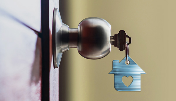A photograph of a key in a home's front door lock.