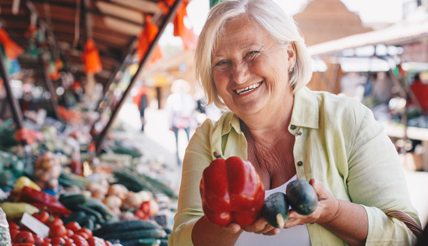 Woman holding up fresh vegetables