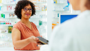 woman showing digital ID to pharmacist