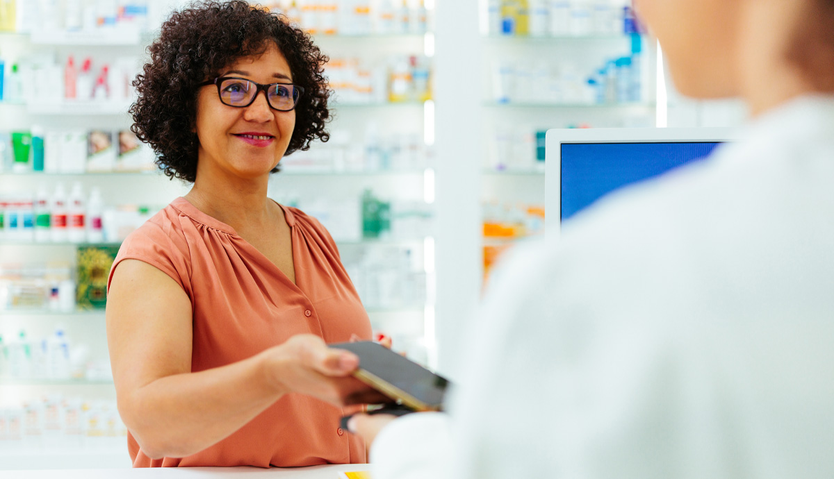 woman showing digital ID to pharmacist