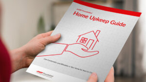 Person holding a printed-out copy of the Home Upkeep Guide