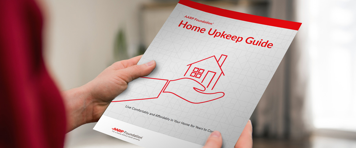 Person holding a printed-out copy of the Home Upkeep Guide