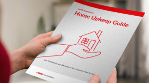 Person holding a printed-out copy of the Home Upkeep Guide