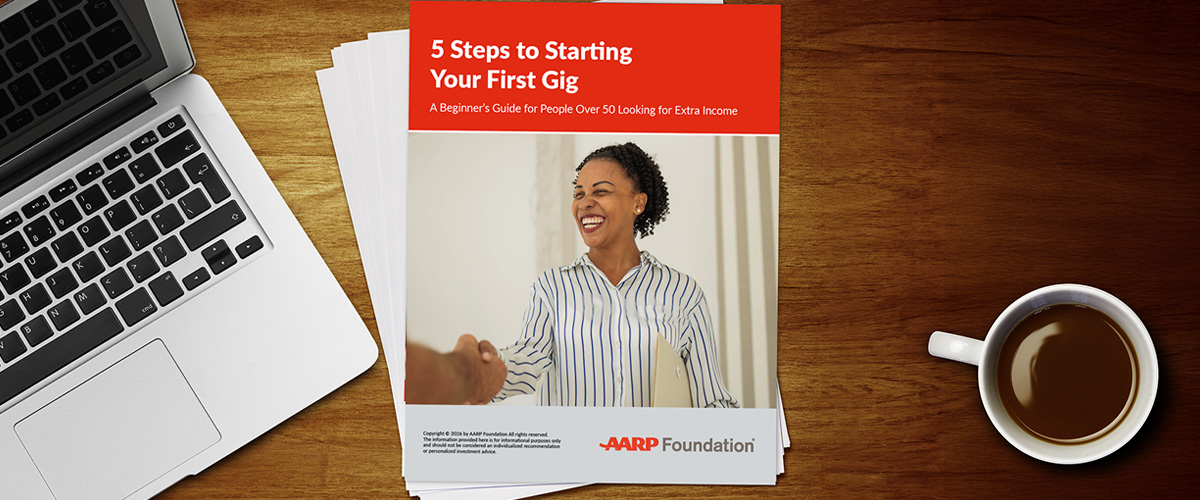 Workbook with name "5 Steps to Starting Your First Gig" on a desk next to a computer and cup of coffee