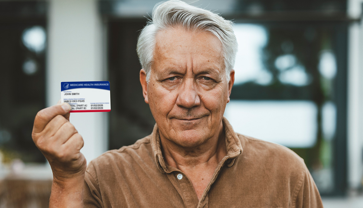 Man in a brown shirt holding a Medicaid card.