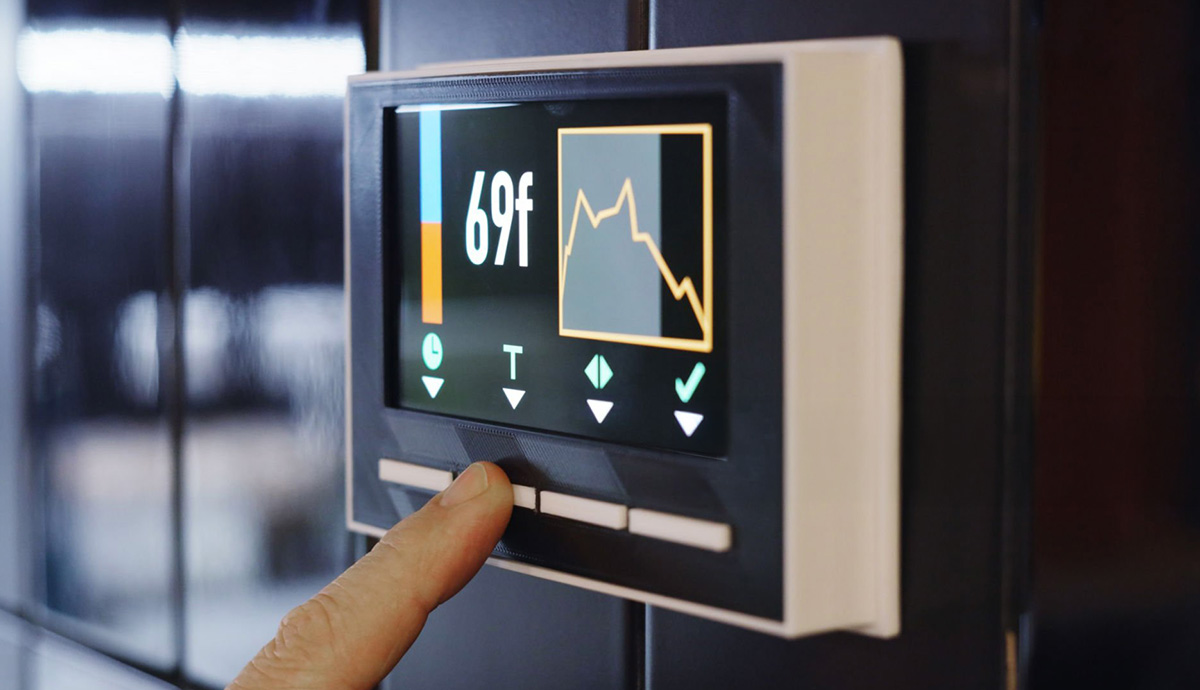 Close up of a thermostat set to 69 degrees.