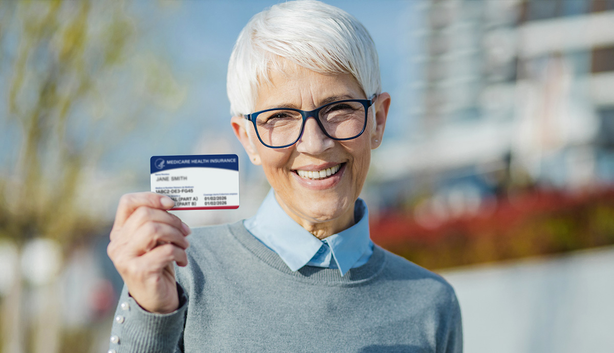 Woman in a blue shirt holding a medicaid card