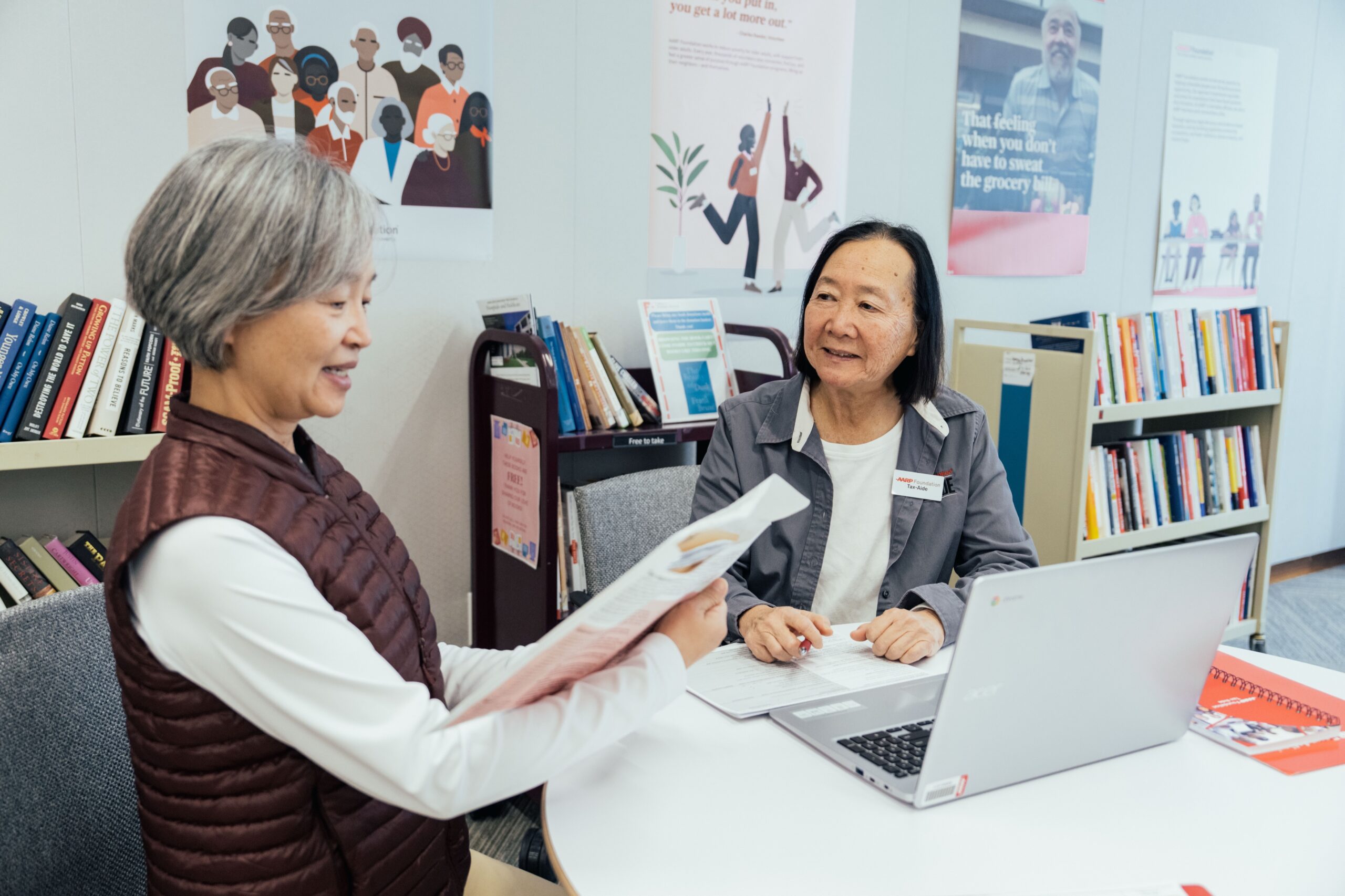 Smiling woman working with a Tax-Aide volunteer on her taxes.